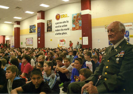 Students in gym with Major Clarence G. Oliver, Jr.